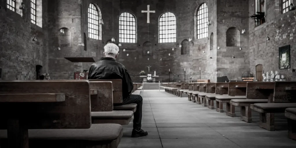 The Fatal Flaw In Popular Christian Theology - lone man in church - 1st John